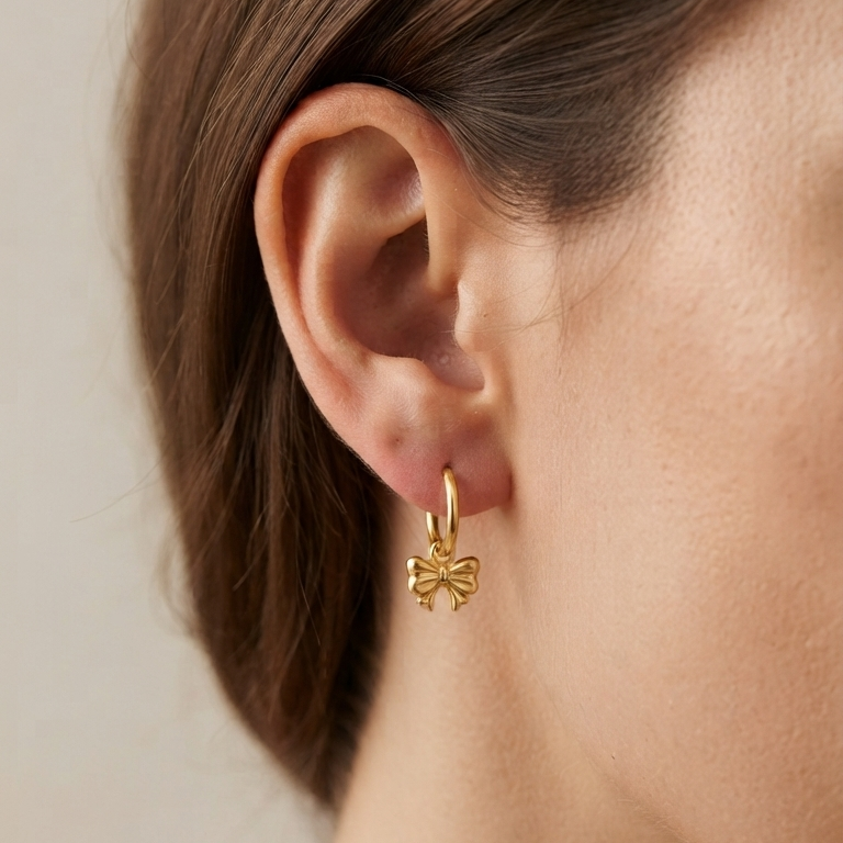 CHLOE Bow Charm Huggie Hoop Earrings worn on ear